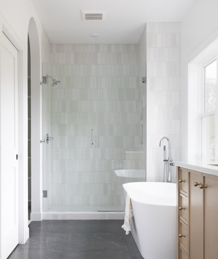 Primary bath with a freestanding tub and a tiled walk-in shower