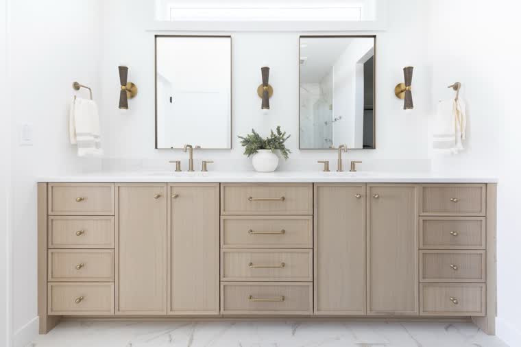 Long oak double vanity with brass hardware and two mirrors
