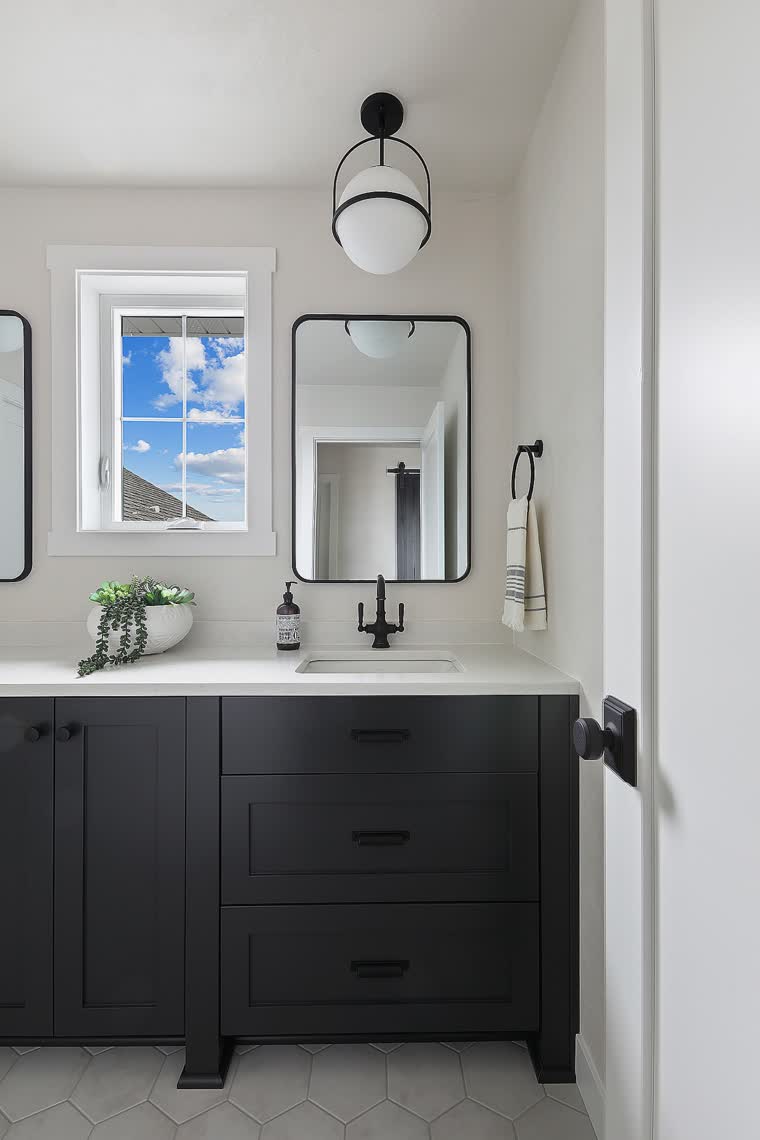 Bathroom with a black vanity and black fixtures