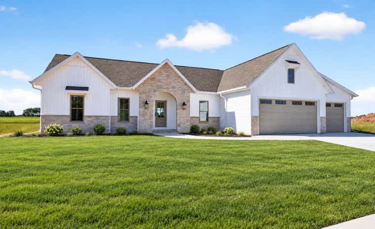 White ranch home with a stone entry and a three-car garage