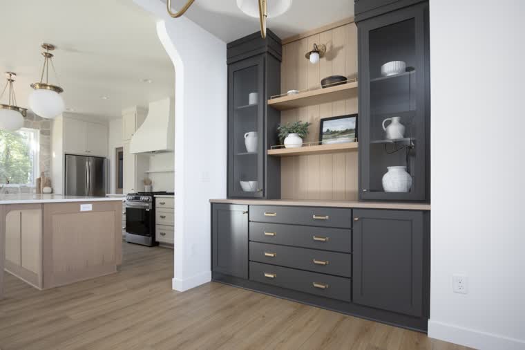 Dark hutch with glass doors and oak shelves beside the kitchen