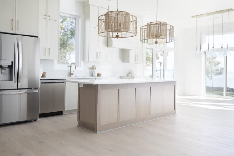 Bright kitchen with an oak island and woven pendant lights