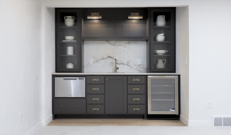 Built-in bar with dark cabinets, a marble backsplash and a wine fridge