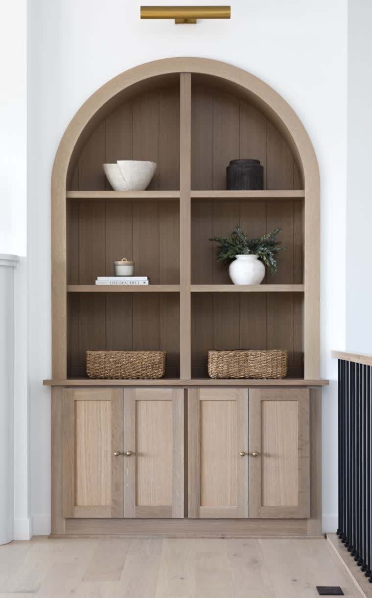 Arched oak built-in bookcase with cabinets below